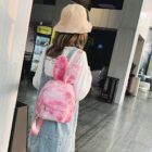 Pink Rabbit Ears Plush Backpack worn by a person, casual style.