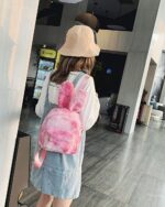 Pink Rabbit Ears Plush Backpack worn by a person, casual style.