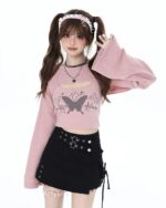 Fairy Grunge Set: Pink sweater top and black skirt with butterfly graphic details.