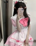 A person wearing a pink Kawaii Maid Uniform Set with a white apron and headband.