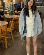 Woman wearing a College Style Zip Up Hoodie - Preppy Aesthetic in an indoor dining setting.