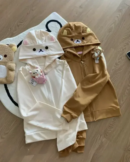 Two Kuma Zip Up Hoodies in white and brown, featuring Jojifuku Aesthetic designs.