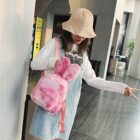 A pink Rabbit Ears Plush Backpack is carried by a person in a casual outfit.