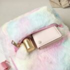 Close-up of a colorful Rabbit Ears Plush Backpack with a wallet and zipper.