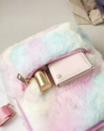 Close-up of a colorful Rabbit Ears Plush Backpack with a wallet and zipper.