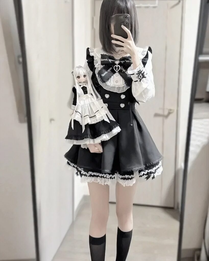Model wearing a Jirai Kei Dress Collection, complete with doll and accessories.