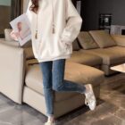 Woman wearing an Ethno-Chic Hoodie, a loose thickened pullover style, casual outfit.