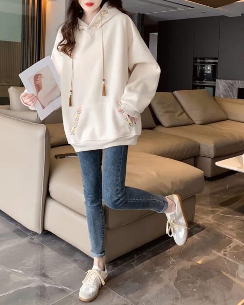 Woman wearing an Ethno-Chic Hoodie, a loose thickened pullover style, casual outfit.