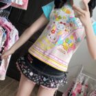 Close-up of a Mezzo Piano Print Top - Jojifuku Aesthetic, featuring a colorful cartoon design.