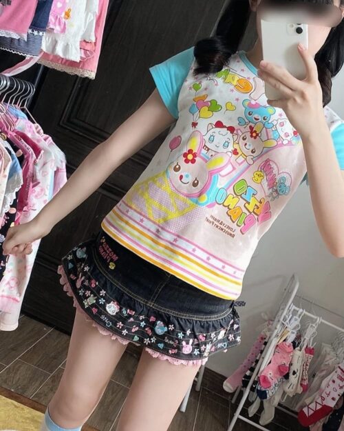 Close-up of a Mezzo Piano Print Top - Jojifuku Aesthetic, featuring a colorful cartoon design.