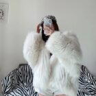 White Thick Fluffy Faux Fur Coat draped over a chair.