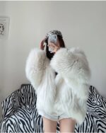 White Thick Fluffy Faux Fur Coat draped over a chair.