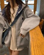 Gray Preppy Aesthetic Hoodie worn by a woman, featuring a zip-up design and large sleeves.