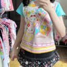 Mezzo Piano Print Top featuring kawaii characters and star embellishments.