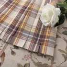 Close-up of a JK Plaid Skirt, featuring a detailed plaid pattern and pleated design.