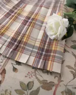 Close-up of a JK Plaid Skirt, featuring a detailed plaid pattern and pleated design.