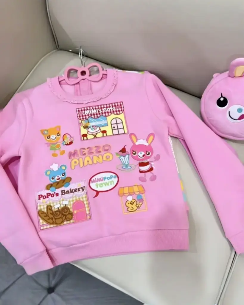 Pink Mezzo Piano Sweatshirt featuring Mimi's Cafe, PoPo's Bakery, and MimiPopo Town designs.