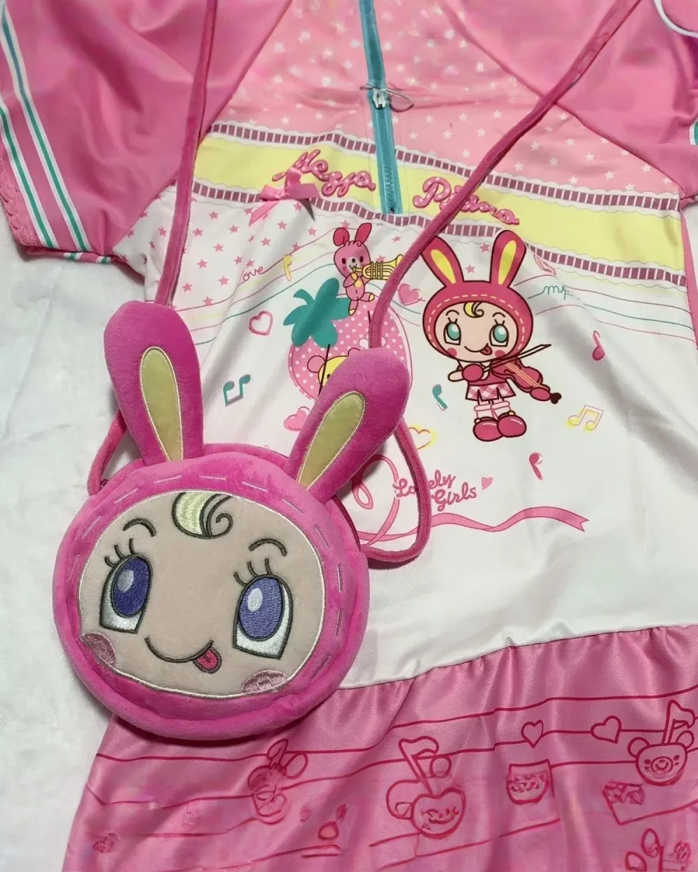 Mezzo Piano Cross Body Bag featuring a plush bunny character and musical print design.