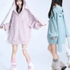 Two models wearing Long Eared Bunny Hoodie with striped zip-up jackets and matching accessories.