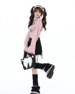 Model wearing a Fairy Grunge Set: pink cardigan and black lace skirt.