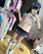 Model wearing the Mezzo Piano Print Top, a Jojifuku aesthetic blouse with playful graphics.