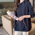 Blue Ethno-Chic Hoodie, loose fit, with decorative tassel details and floral embroidery.