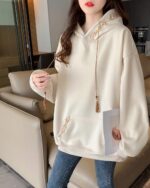 Cream-colored Ethno-Chic Hoodie with embroidered details, loose fit, and drawstring tassel.