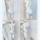 Two Lolita Inspired Swimwear sets displayed on mannequins. One is a two-piece, the other a one-piece with a flowing skirt.