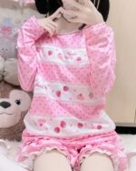 Close-up of a pink Mezzo Piano Shirt featuring strawberries, cupcakes, and a kawaii aesthetic.