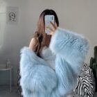 Light blue Thick Fluffy Faux Fur Coat draped over a phone.