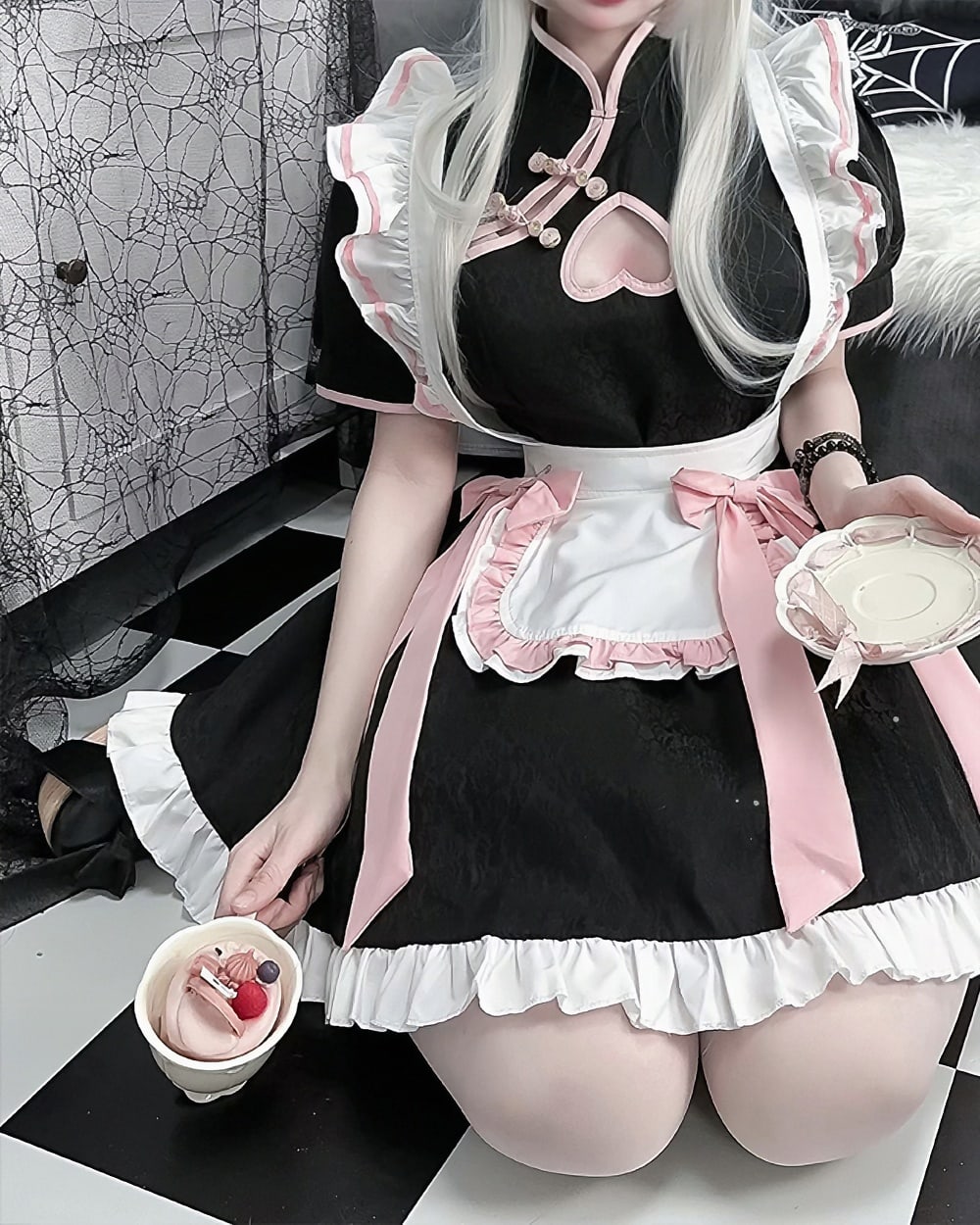Black and white Kawaii Maid Dress with lace trim and bow, worn by a model.