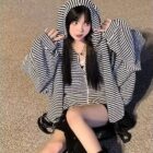 Woman wearing a Long Eared Bunny Hoodie, black and white striped, Harajuku aesthetic.