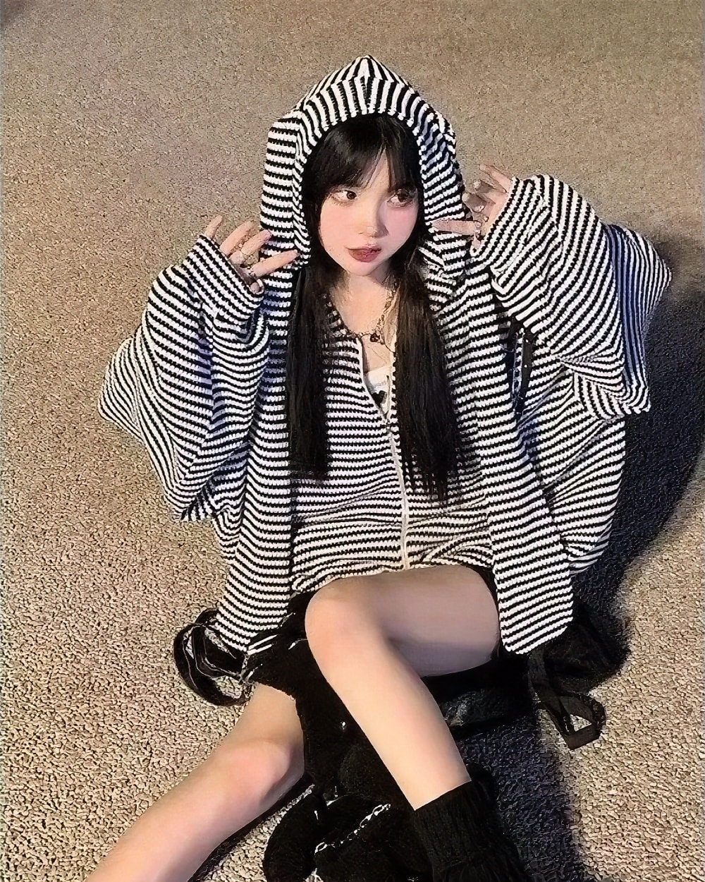 Woman wearing a Long Eared Bunny Hoodie, black and white striped, Harajuku aesthetic.