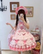 A young woman wearing a pink Hime Lolita Dress, with lace details and ribbons, posing for a selfie.