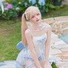 Model wearing a Water Melody Lolita Inspired Swimwear, featuring a light blue and white lace design.