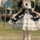 A black and white Hime Lolita Dress Collection, featuring layers, lace, and ruffled details, with white socks and gloves.
