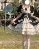 A black and white Hime Lolita Dress Collection, featuring layers, lace, and ruffled details, with white socks and gloves.
