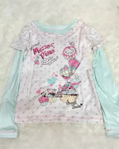 Long Sleeves Mezzo Piano T-Shirt featuring cupcakes and musical notes on a polka dot background.