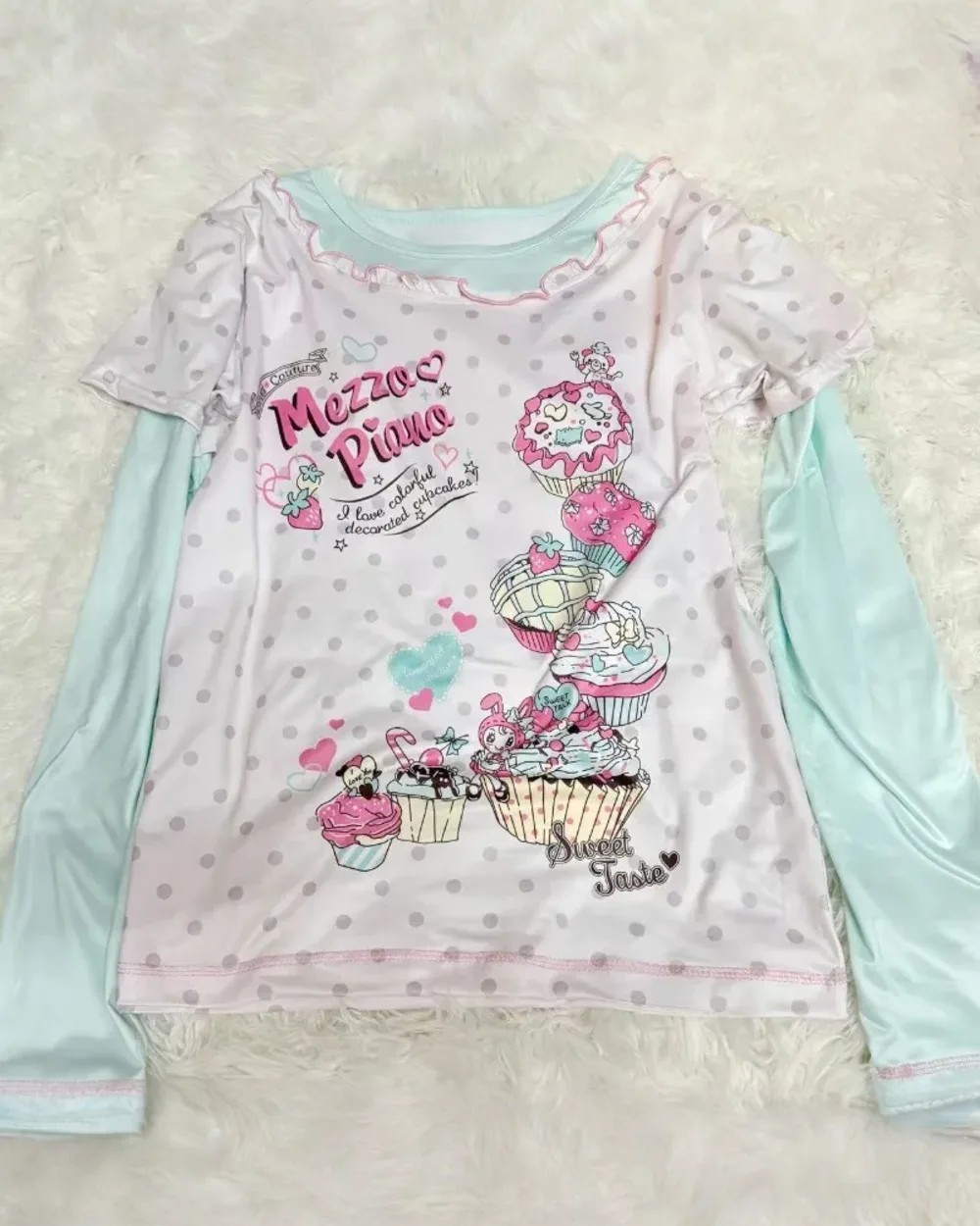 Long Sleeves Mezzo Piano T-Shirt featuring cupcakes and musical notes on a polka dot background.