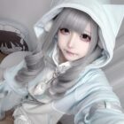 Model wearing a light blue Kawaii Gamer Hoodie with cat ears and a plushie.