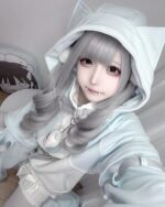 Model wearing a light blue Kawaii Gamer Hoodie with cat ears and a plushie.