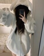 Person wearing a white Fluffy Bear Paw Hoodie with a hood and zipper.