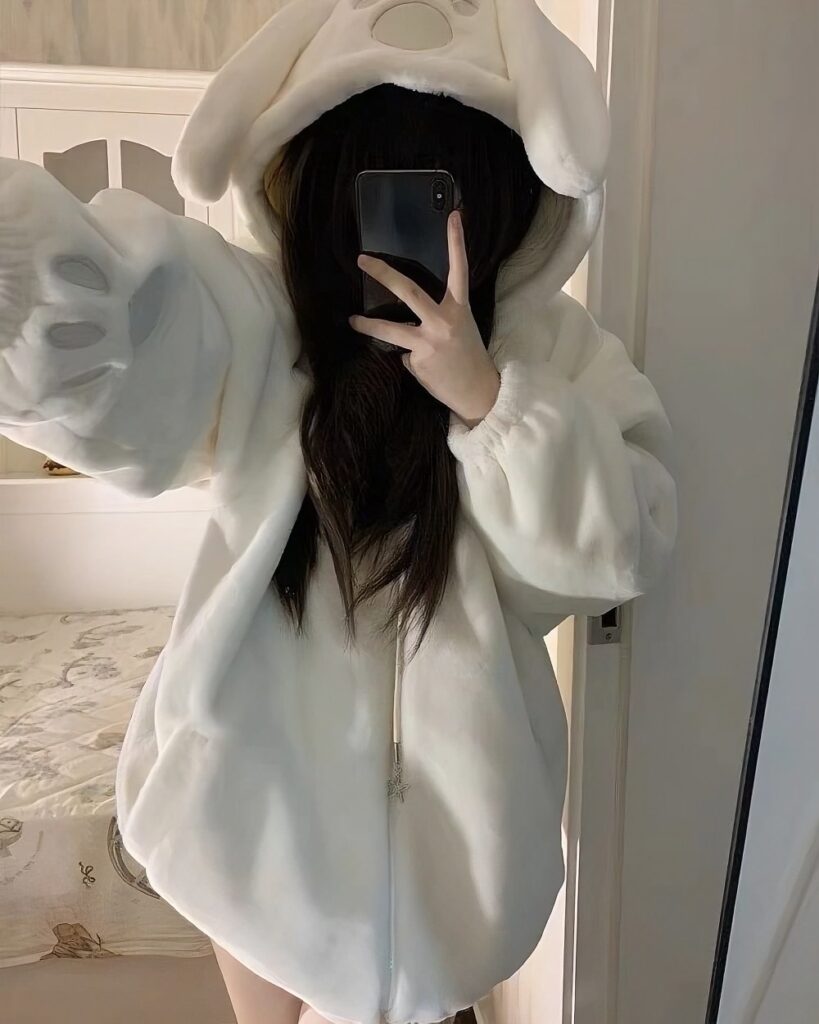 Person wearing a white Fluffy Bear Paw Hoodie with a hood and zipper.