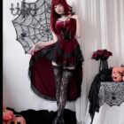 Woman wearing a maroon Dark Nun Dress with lace trim, velvet bodice, and black lace stockings. Romantic goth aesthetic costume.