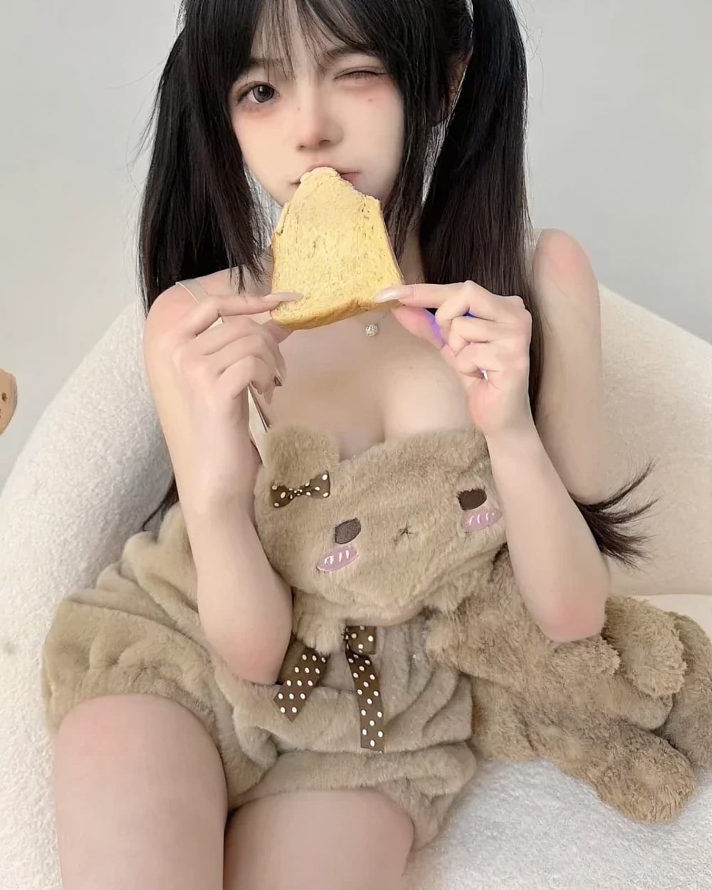 Woman wearing Soft Plush Bear Pajamas, a brown teddy bear-themed sleepwear set.