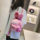 Pink Rabbit Ears Plush Backpack shown carried by a person.