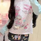 Long Sleeves Mezzo Piano T-Shirt featuring a whimsical design with sweets and characters.