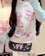 Long Sleeves Mezzo Piano T-Shirt featuring a whimsical design with sweets and characters.