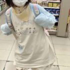 Woman wearing a Kawaii Panda Pastel Long Sleeve t-shirt in a store.