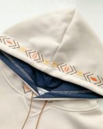 Close-up of a Loose Thickened Pullover Hoodie - Ethno-Chic Hoodie featuring embroidered arrow designs.